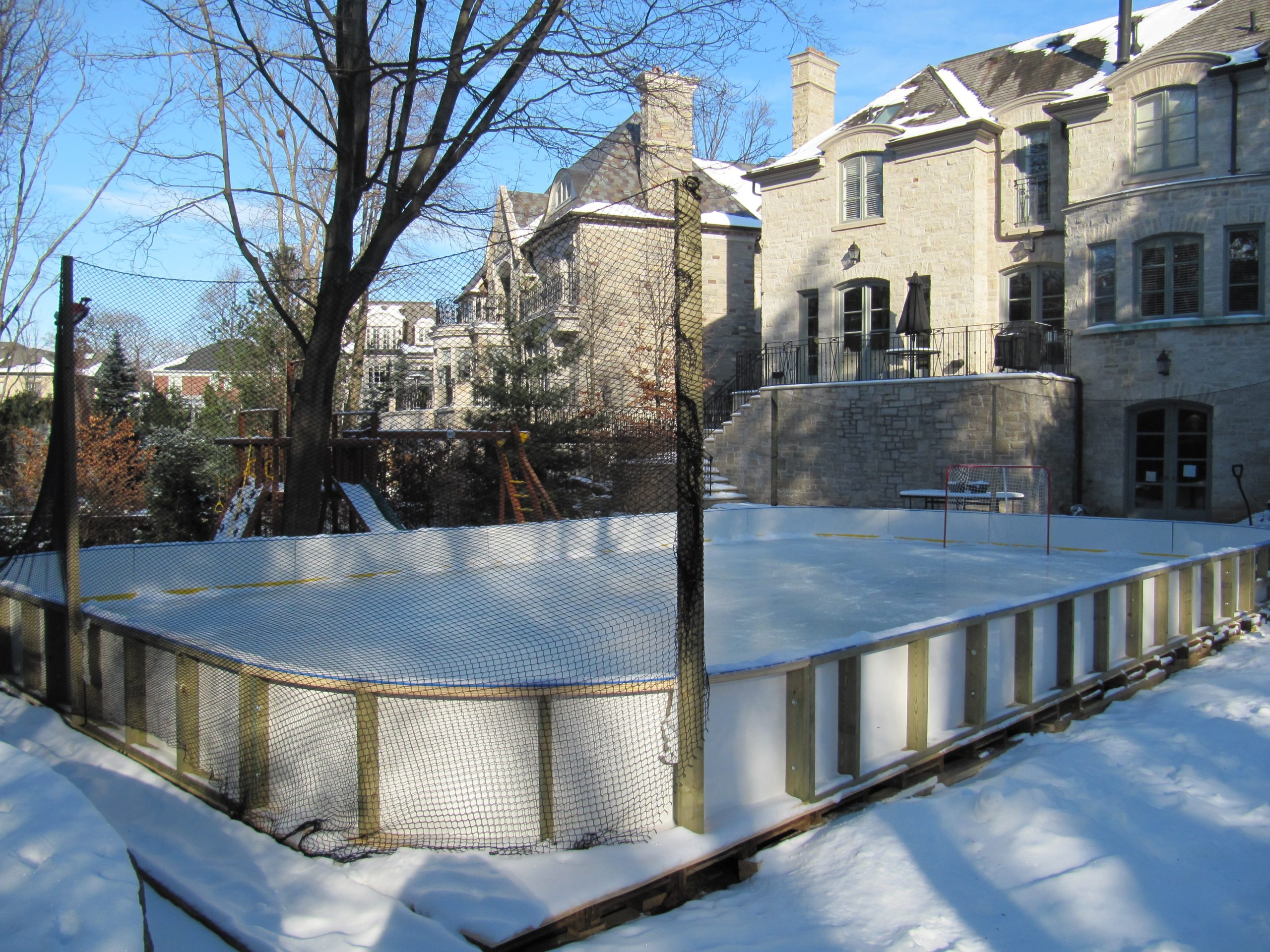 Residential rink in a snowy setting
